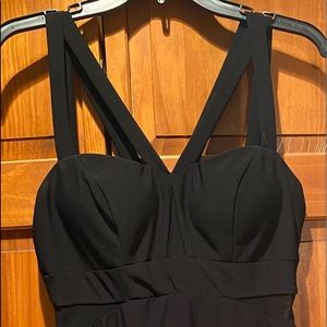 Women’s black dress. Two straps on each shoulder. See-through sides. Worn once